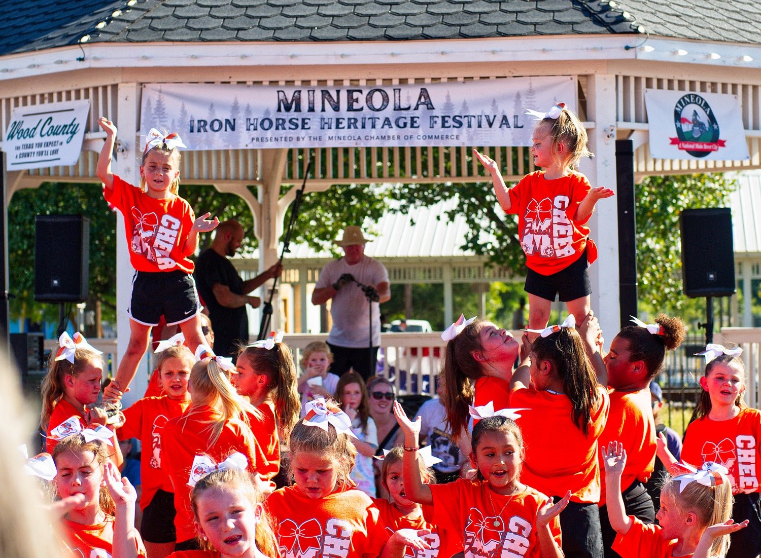 Students from Mineola Cheer Academy perform Saturday afternoon in downtown Mineola. [additional iron horse images available]